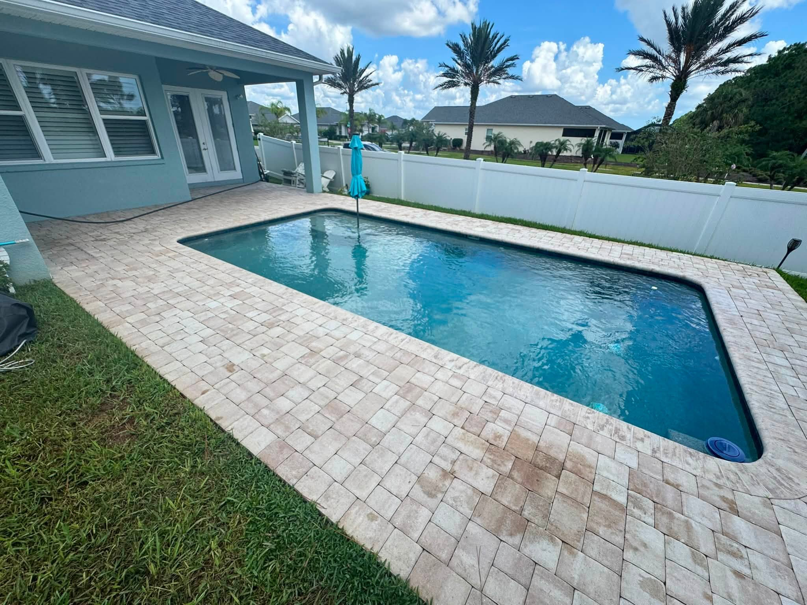 Pool deck pavers before paver sealing by Sunshine Pressure Washing